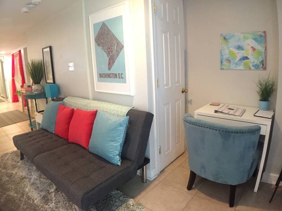 Living room with workspace and convertible love seat