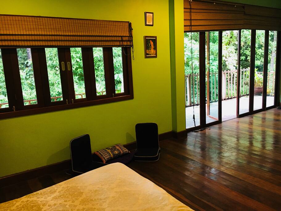 Balcony doors open on to jungle and sea views .