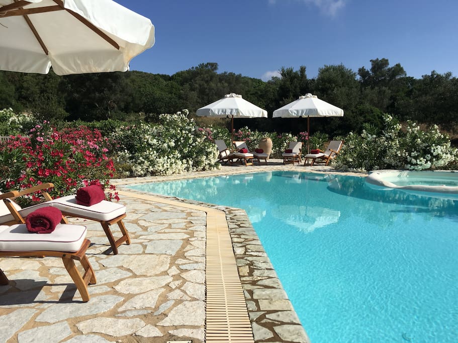 relaxing round the swimming pool on teak deck chairs.