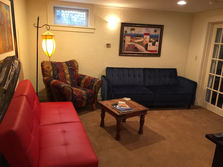 Comfortable living room with two fold down couches for extra sleeping options in addition to the queen bed in bedroom and full bed in sleeping cubby.