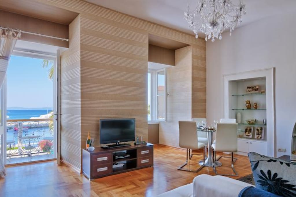 open plan living area with a balcony and sea view