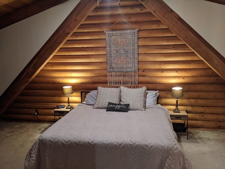 Master bedroom, king sized bed with a twin loveseat pullout (best for a child). Master bedroom also has a small desk for any working from the cabin needs!