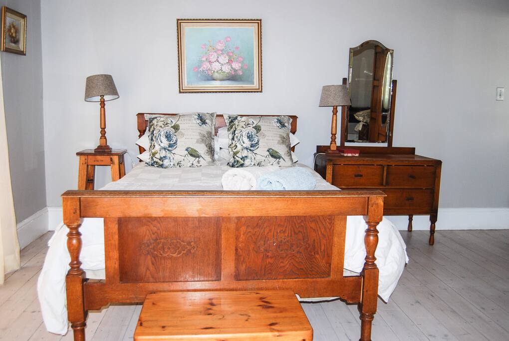 Bedroom 1 with door leading to a private garden area and the shared pool. Desk and ample space.
