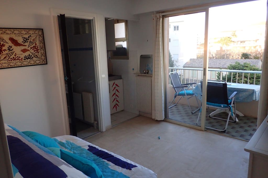 Entrance of bathroom (left) and kitchen corner (right).