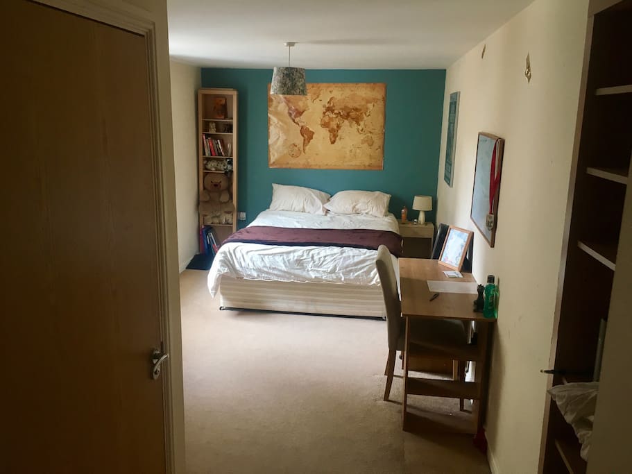 Spacious room with desk, door to ensuite