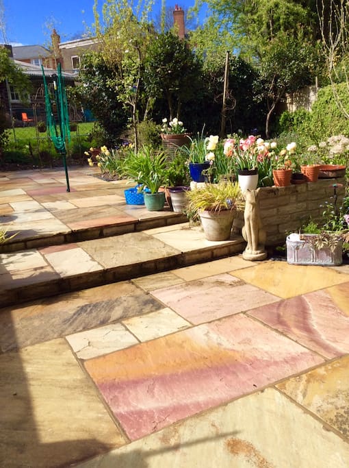 The courtyard garden with sandstone paving, designed by my sister