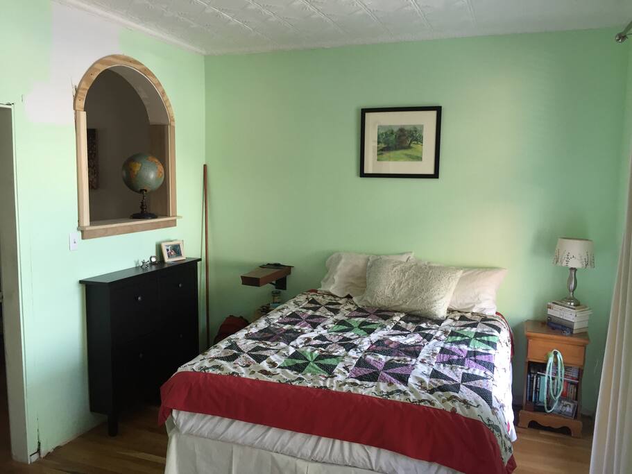 Bright bedroom with interior arched window into the living space