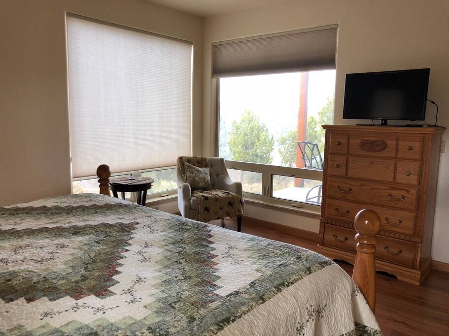 Shows your nice king size bed with a view of your private patio