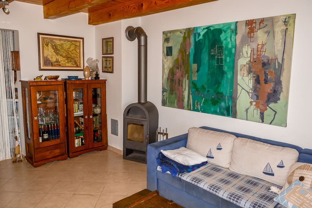Living-room with a convertible sofa bed for two. There is also a wood stove for the colder times of the year or simply for some romantic atmosphere.