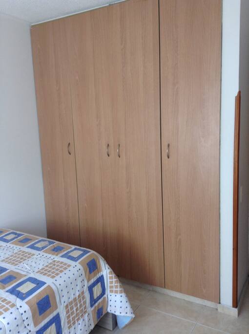 4 door closet that allow you to arrange suits, pants and shirts. In the middle there are a couple drawers.