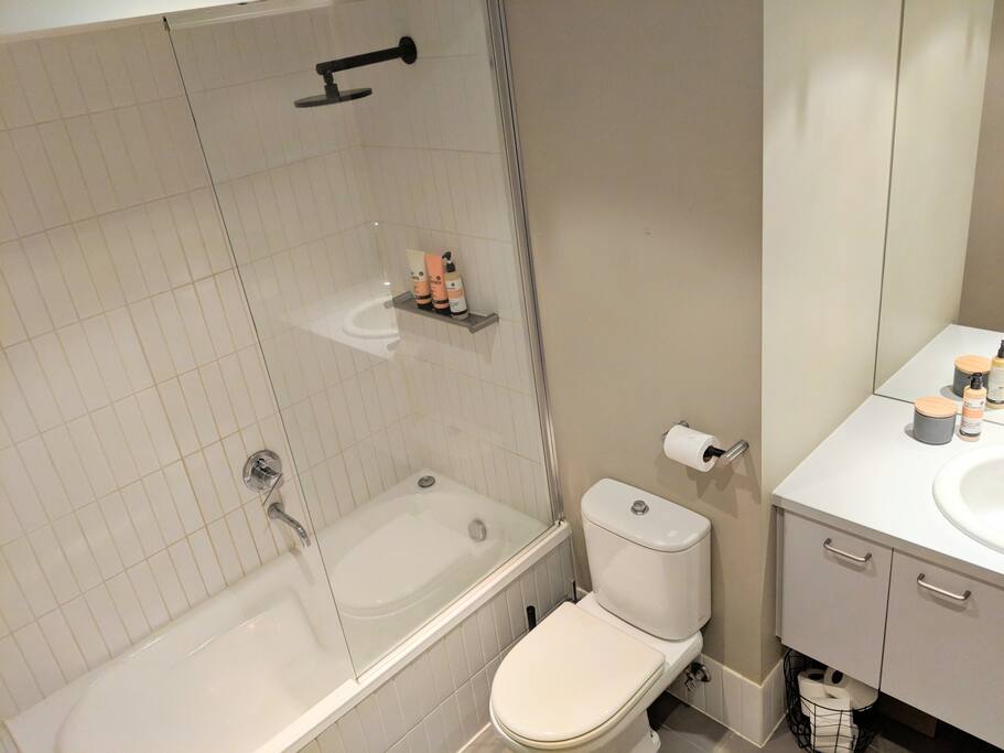 Fully stocked bathroom with fresh towels, shampoo, conditioner, soap, body wash, toilet paper, hair dryer and even shower caps!