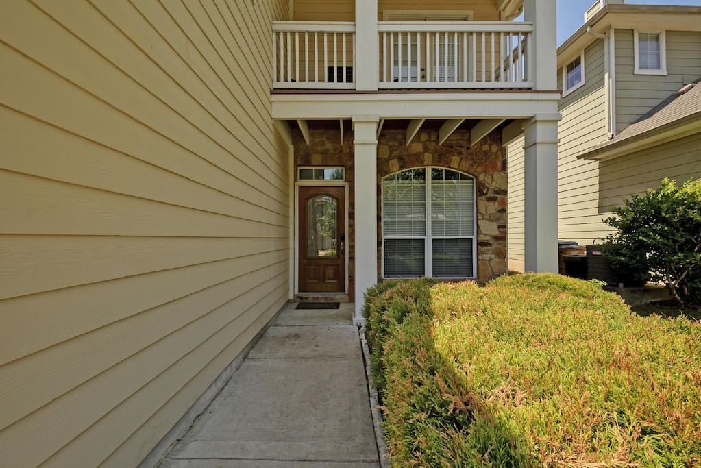 Access the secluded front entrance via the side of the house.