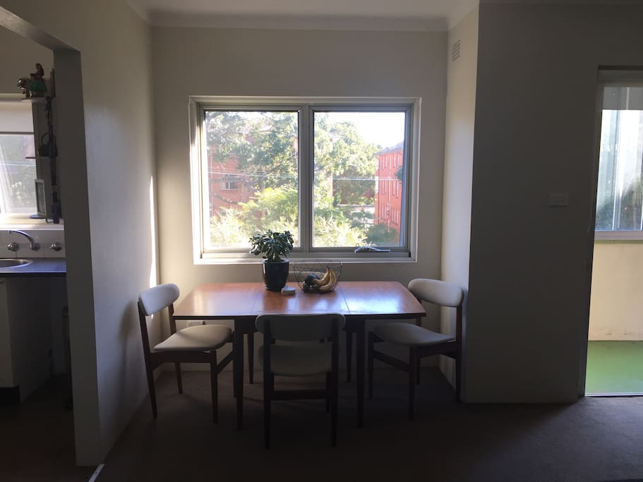 Light-filled dining area with balcony on the right.