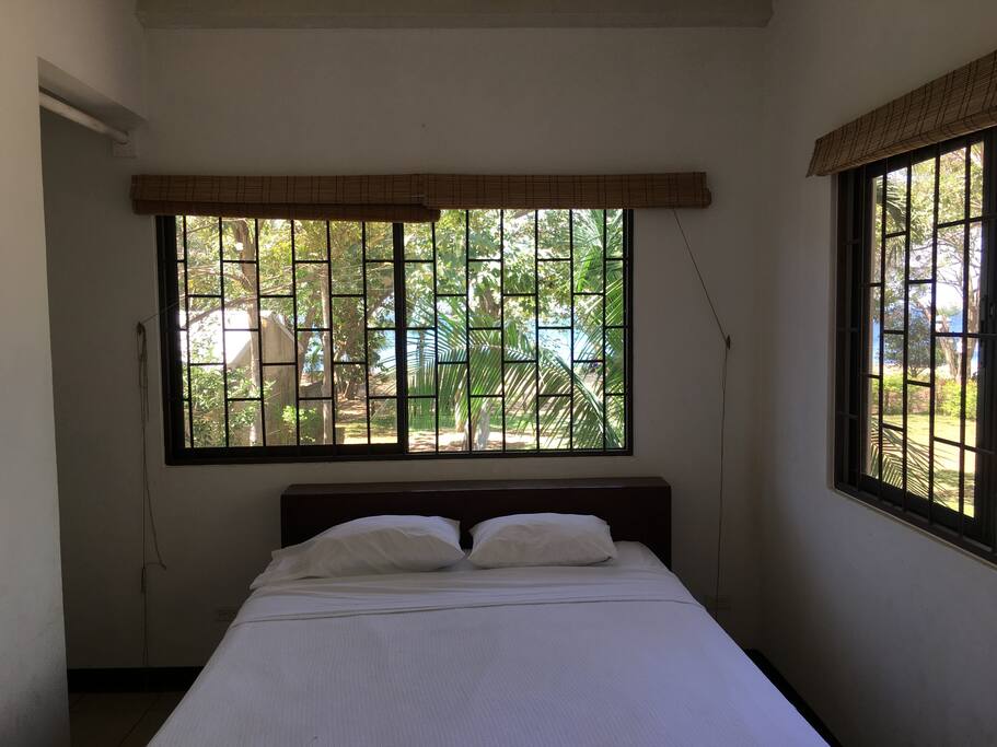 A queen bed from which you'll be hearing the waves while you sleep.