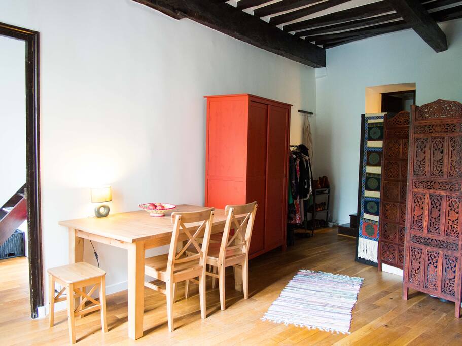 The living room features a large dining table...