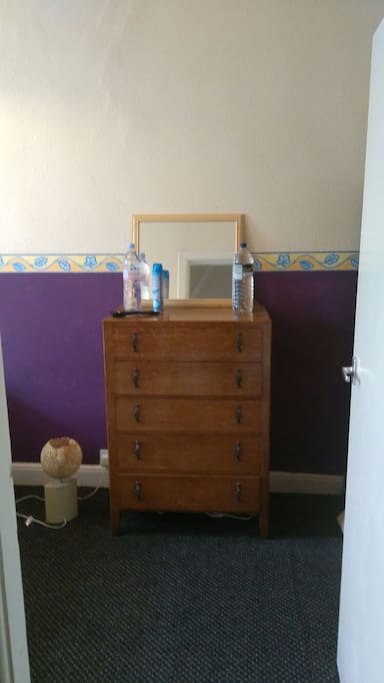 Chest draws + mirror + lamp in the bedroom