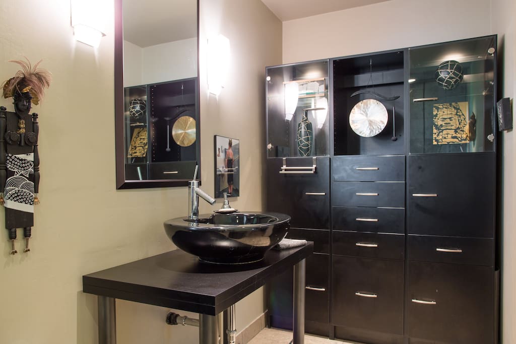 Master Bathroom Cupboard with Art Objects collected from around the world.