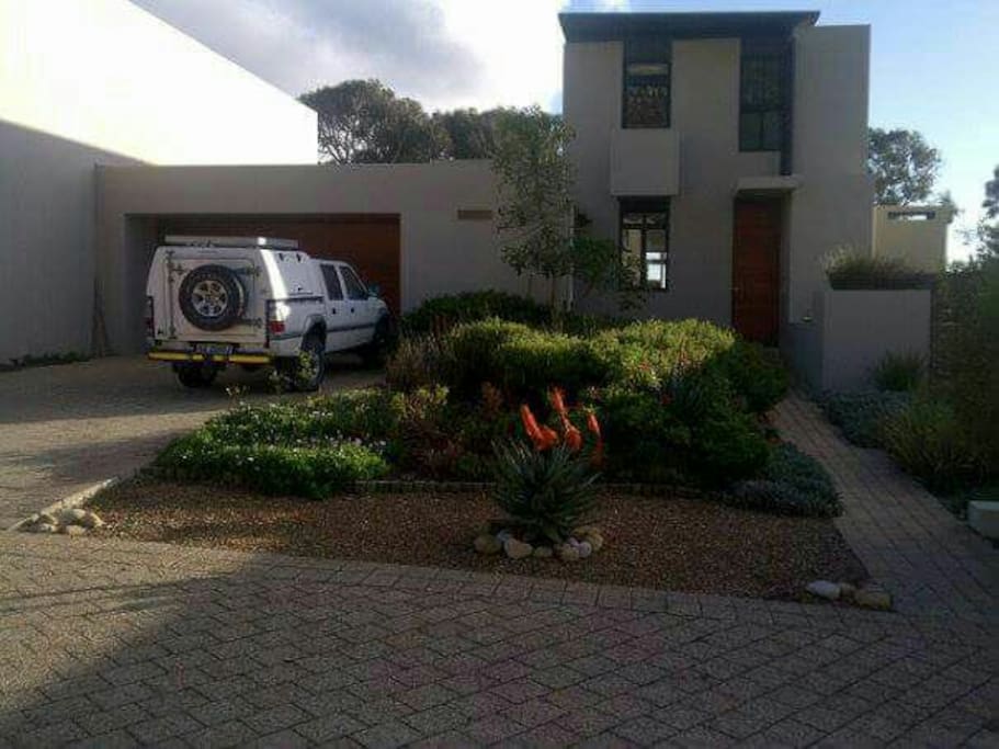 The front entrance of the townhouse with space for parking 3 cars outside.