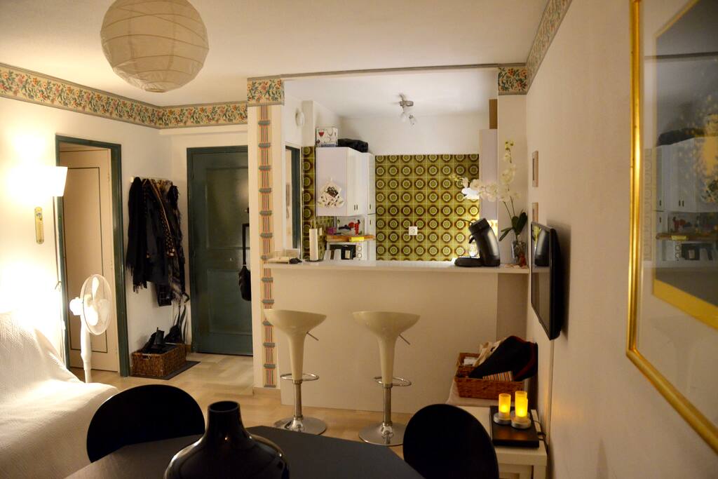 Entrance to the apartment and the open full kitchen with bar and two bar chairs for entertaining the chef in the kitchen :)