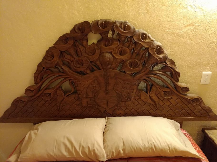 Headboard of the bed with a work by Diego Rivera hand engraved in wood.