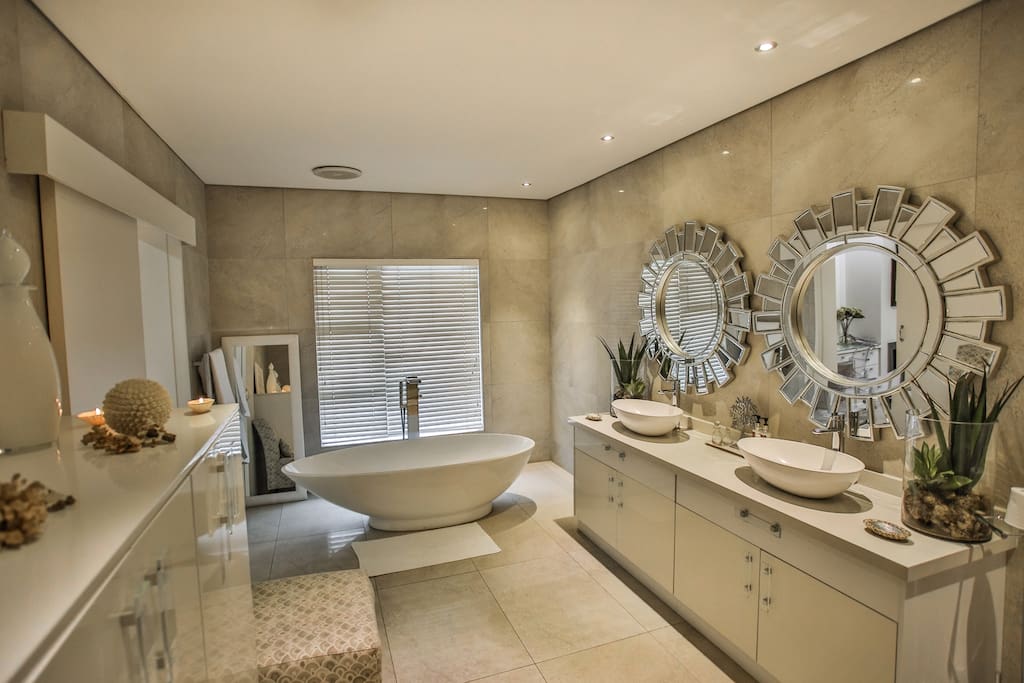 Poseidon's bathroom with egg-shell bath and twin basins