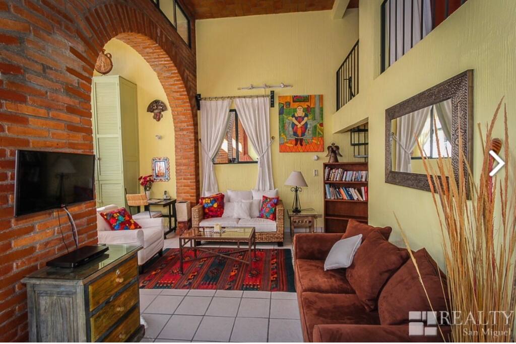 A photo of the TV and living room area with plenty of comfortable seating of good conversation!