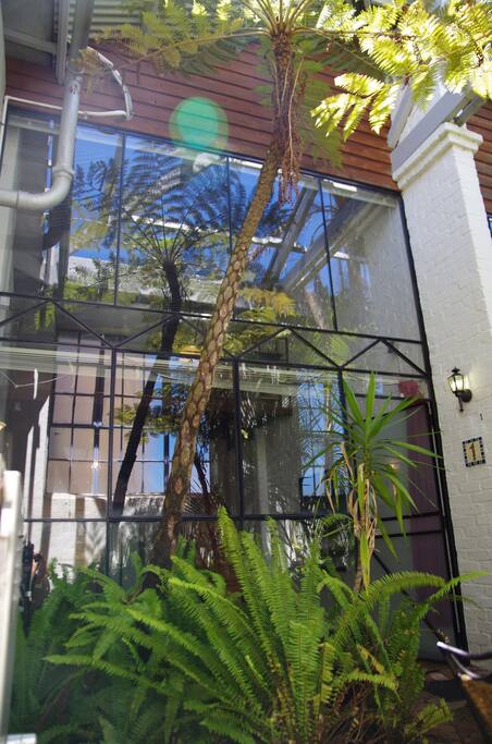 Double height glass wall gives the loft and the apartment a really open light filled feeling.
