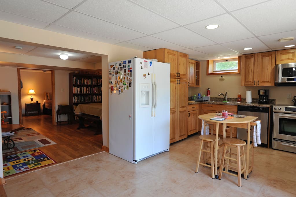 Walk through French door to kitchen leading to dining room/library and into large bedroom.
