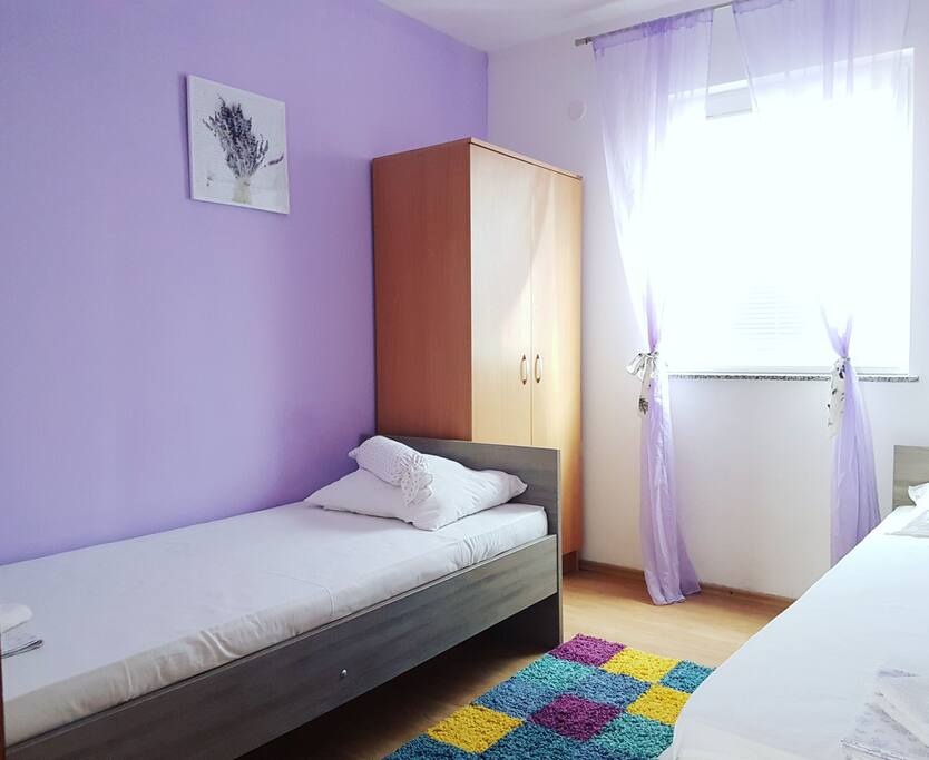 Lavander bedroom for two with cozy new mattresses