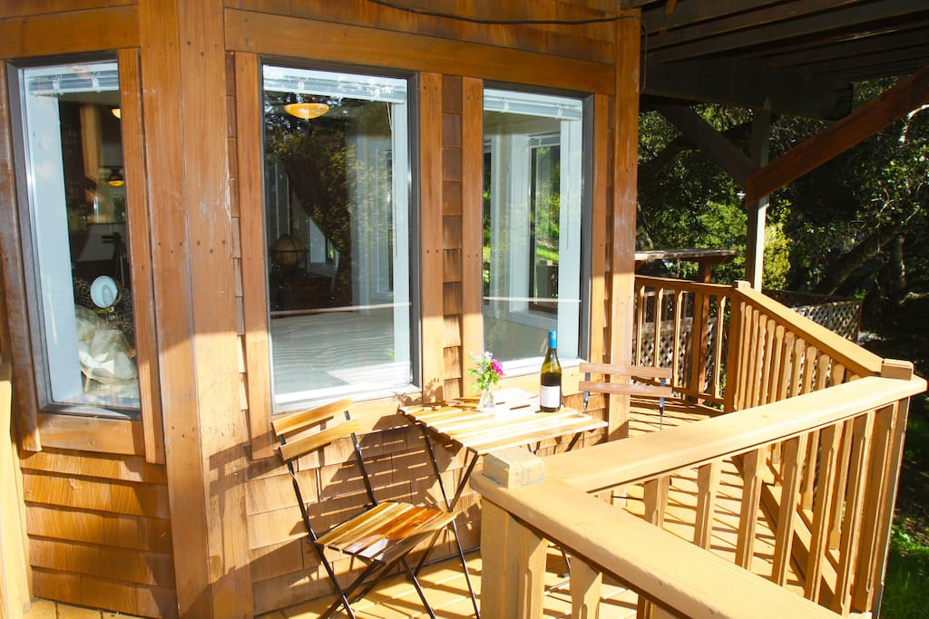 Private deck seating area with views of mountains and garden.