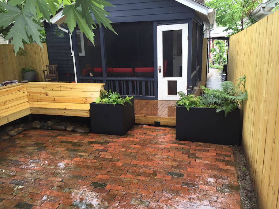 Back patio with large bench and fire pit