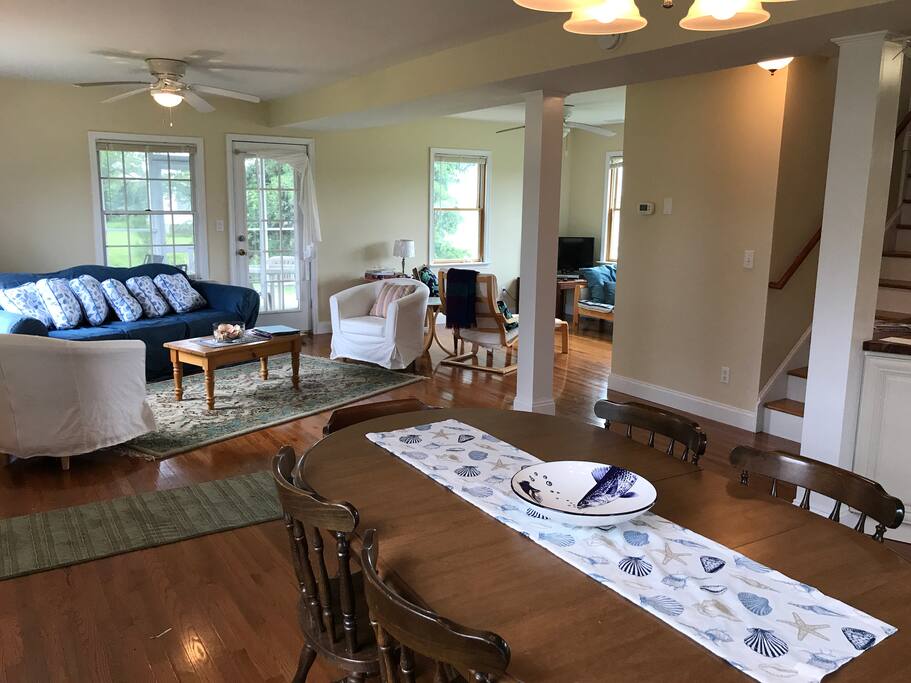 view of open floor plan from dining room into living room and media space