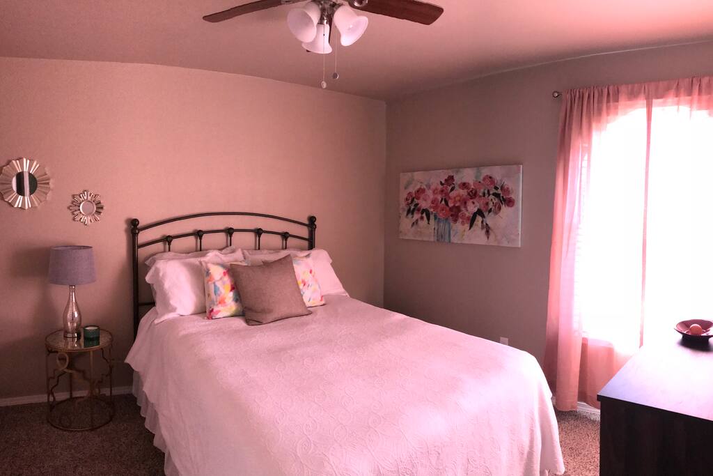 Queen Size bed with an overhead fan