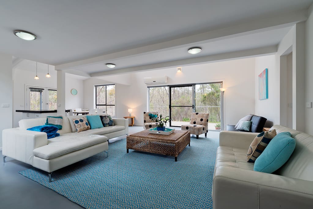 light filled, spacious and stylishly decorated open plan living area with views of nothing but trees from every window!