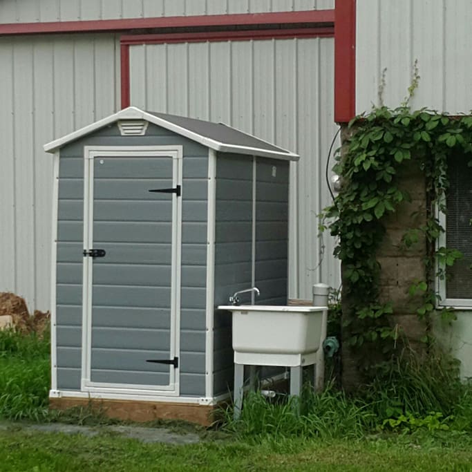 Outdoor flushing toliet and outdoor hand wash station.
