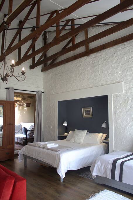 The high ceiling and exposed roof beams add character to the room. A view into the private ,covered verandah.