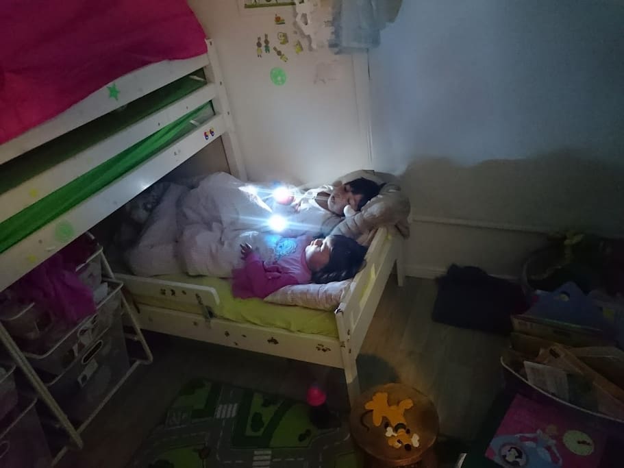 The smaller of the two beds in kids bedroom (large one on left above)