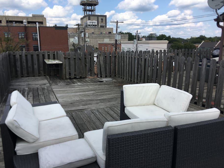 Rooftop deck with seating.