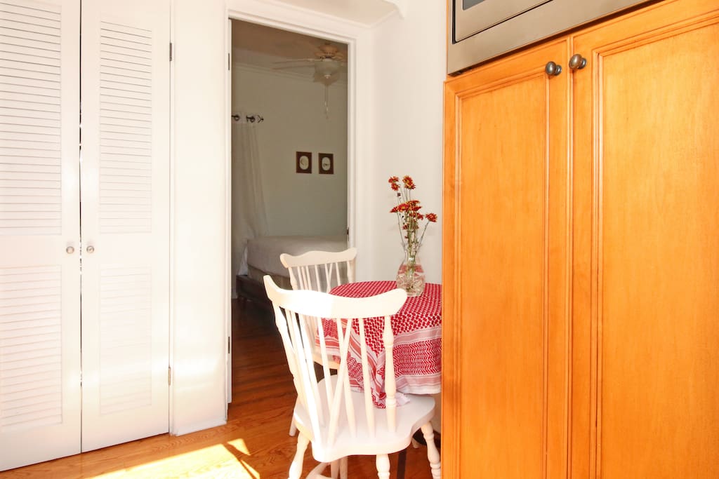 Adjoining shared laundry room and breakfast nook with washer and dryer behind the louvered doors.