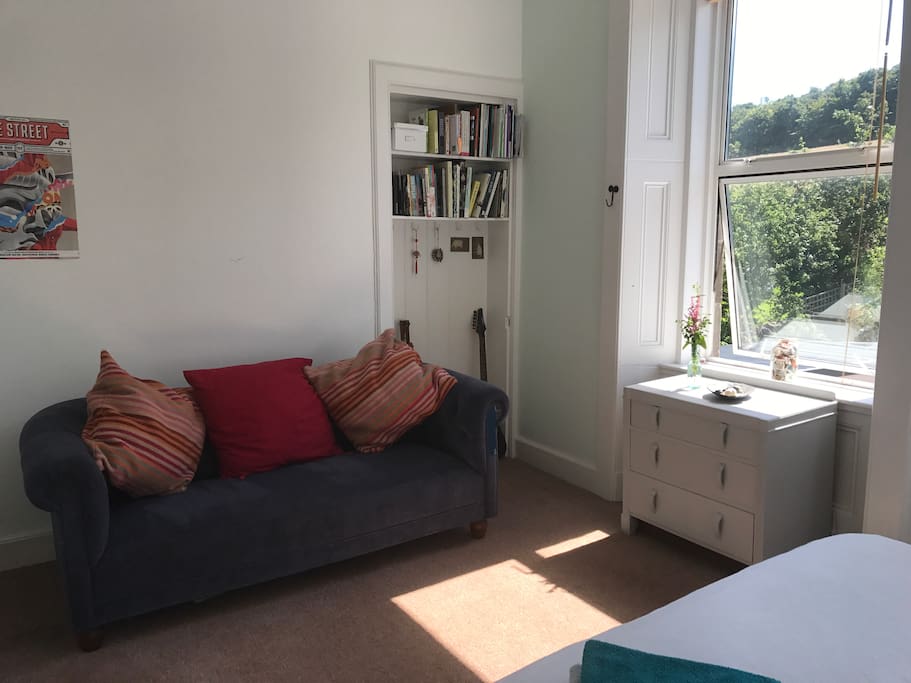 Comfortable double bedroom with king sized bed and settee. Over looking landscaped garden.