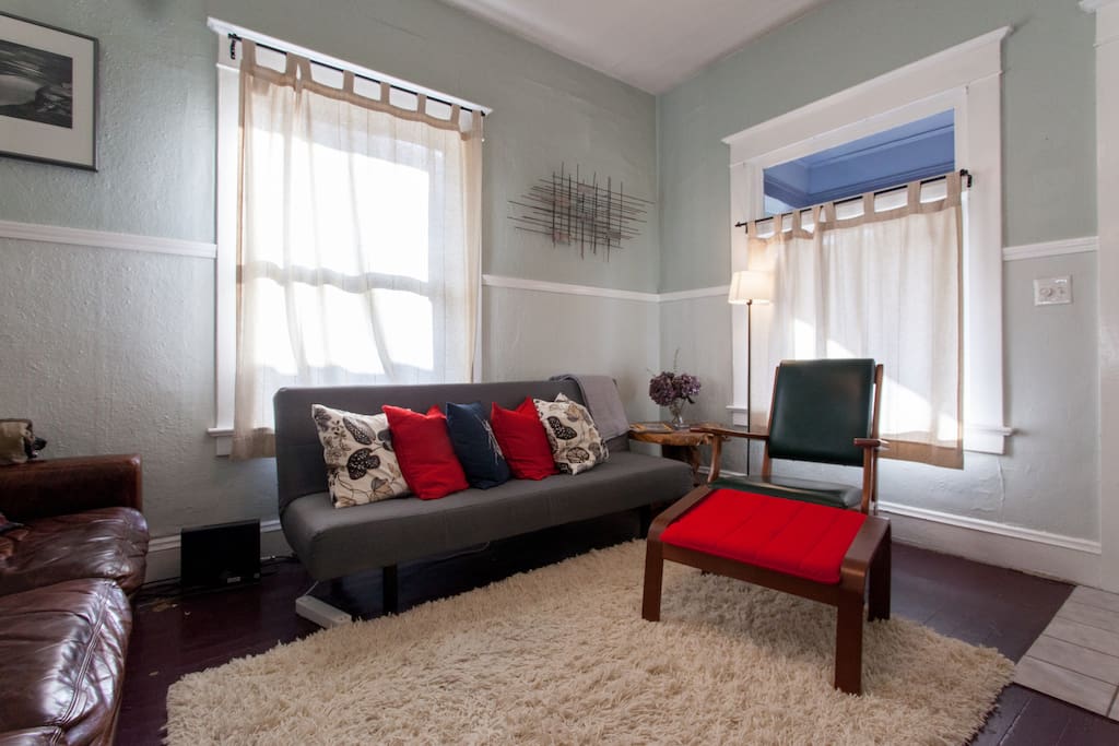 Cozy living room with futon that sleeps one adult