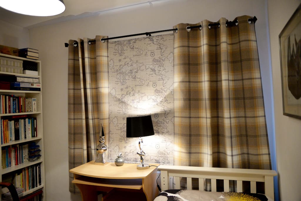 Desk with view through the window. The blind is down in the photo.