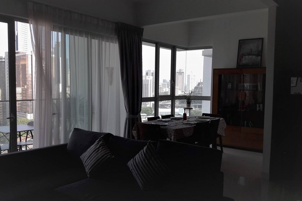 Living and dining room with a city view