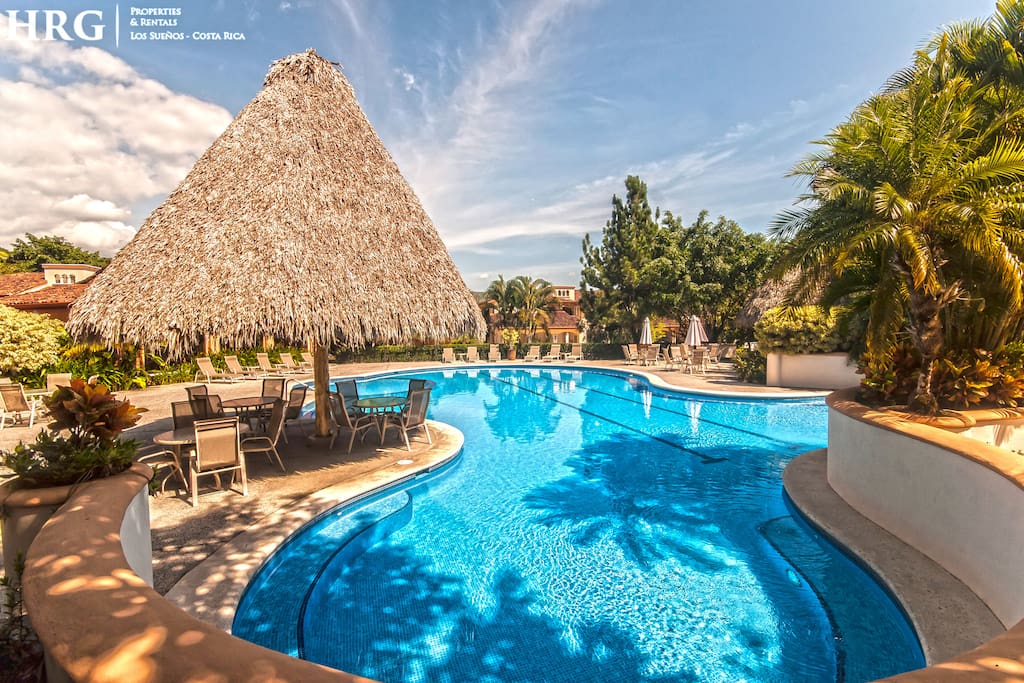 Pool area with shaded palapas at the colina community