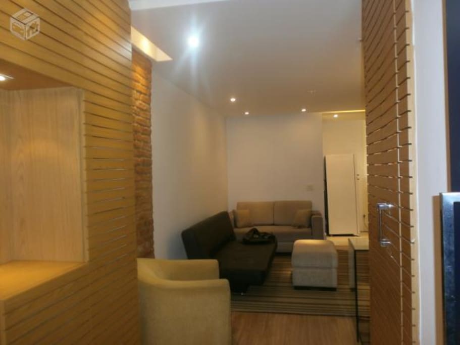 Newly decorated air-conditioned living room with flatscreen TV.