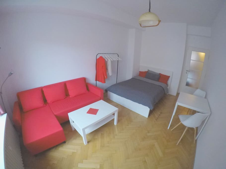 Cozy room with all you need to feel comfortable, double bed, sofa and table with chairs.