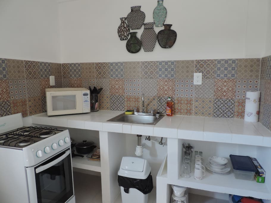 The kitchen features a full sized stove,oven,fridge,microwave as well as purified water!