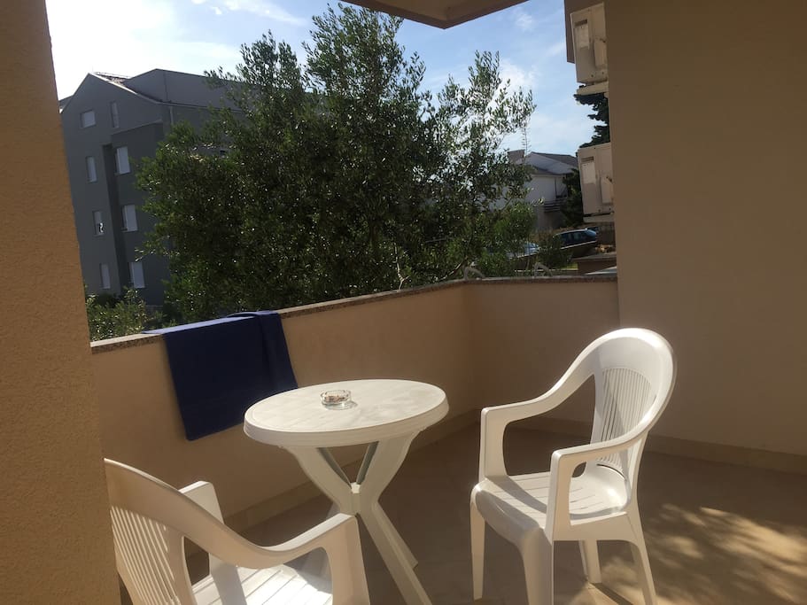 Balcony with table and chairs.