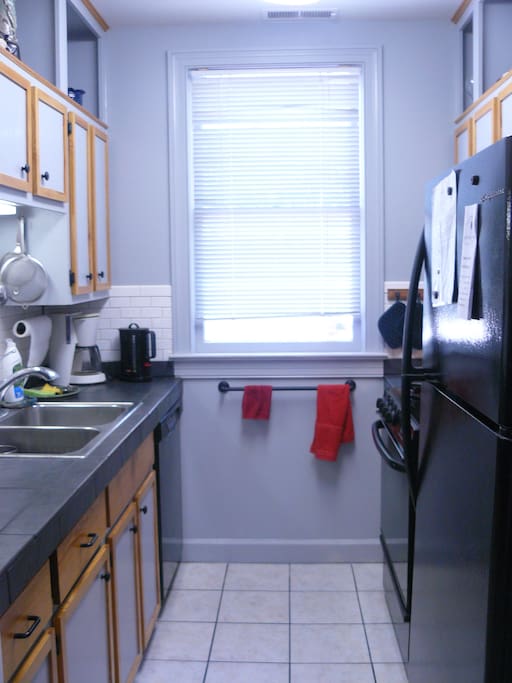 Kitchen window overlooks a landscaped parking area. Gas range and fully equipped kitchen.