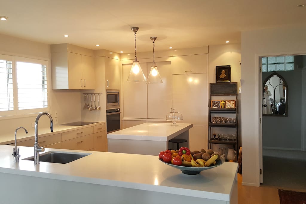 A large kitchen has all the mod cons, waste-master, coffee maker, microwave, induction hob, fridge/freezer, water filter. The washing machine and drier are tucked away behind cupboard doors in the kitchen.